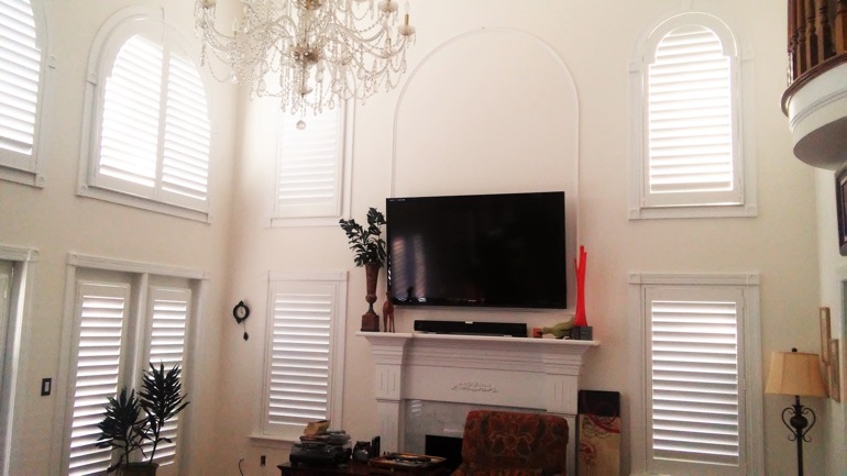 Cleveland great room with mounted television and arc windows.
